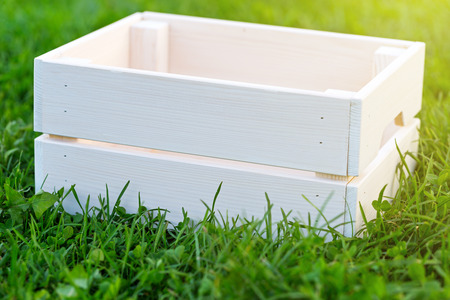 Empty wooden crate on grass, outsideの写真素材