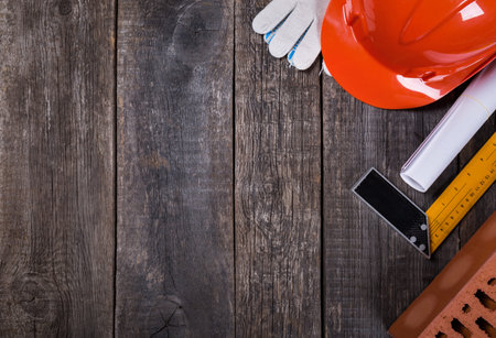 Construction tools closeup on wooden background