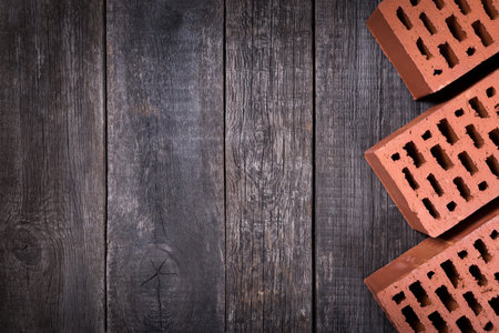 Red bricks closeup on wooden background