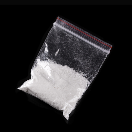 Cocaine in plastic packet on black background, closeupの写真素材