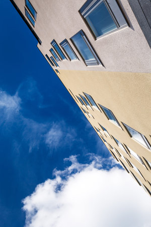 Building walls with windows on blue sky background. Outside