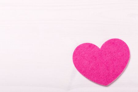 Heart shape on white rustic wooden tableの写真素材