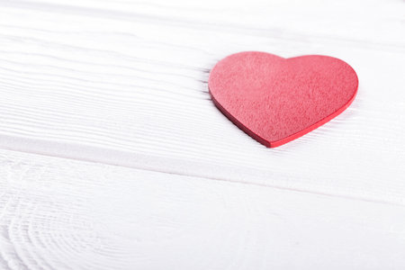 Heart shape on white rustic wooden table