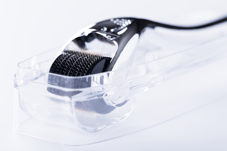 Derma Roller on white, microneedle mesotherapy for skincare, rejuvenating treatment concept.の写真素材