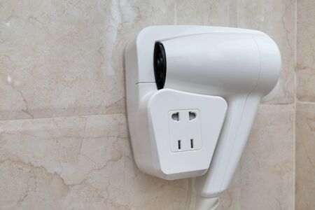Hotel hand hairdryer on wall, closeupの写真素材