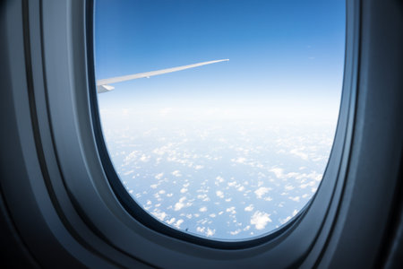 View from airplane window to the sky and plane wing, nobody