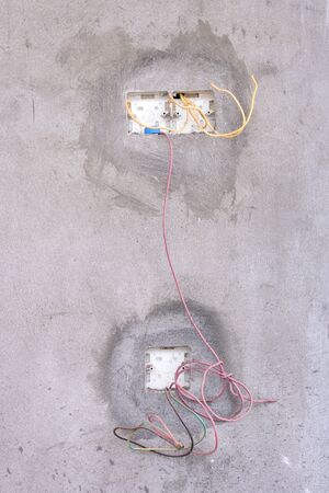 Unfinished electricity wall socket. Open and under constructionの写真素材