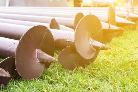 Stack of screw piles for house foundation, closeup. Nobody. Outdoors on construction siteの写真素材
