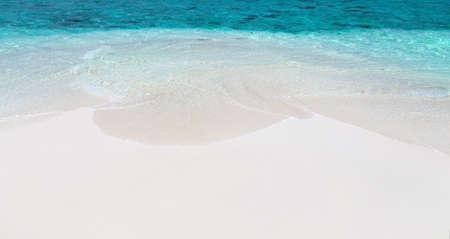 Handwriting word "Maldives" on maldivian beach drawn on sand, travel destinations concept cardの写真素材