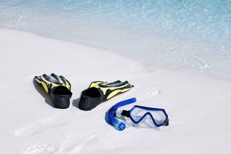 Swimming mask, fins and tube on white sandy seashore. Tropical vacation on beach. Nobodyの写真素材