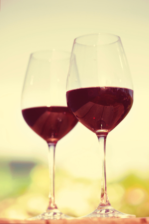 Two glasses with red wine, outside on nature backgroundの写真素材