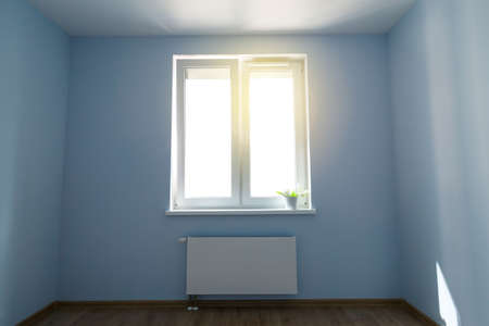 Interior of empty unfurnished room with walls, window and radiator, nobodyの写真素材