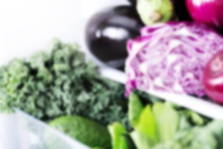 Blurred fresh food background,  vibrant colour vegetables and fruits inside on fridgeの写真素材