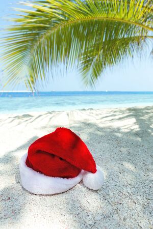 Santa Claus hat on perfect tropical beach, Christmas greeting cardの写真素材