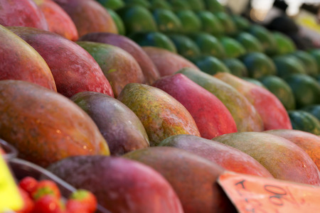 A lot of ripe tasty mango in assortment on food and fruit market, nobody, shallow depthの写真素材