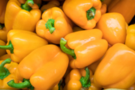 Ripe red paprika on sale at the market, closeup. Blur background
