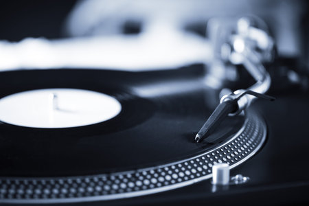 Turntable with black record and headshell, closeup