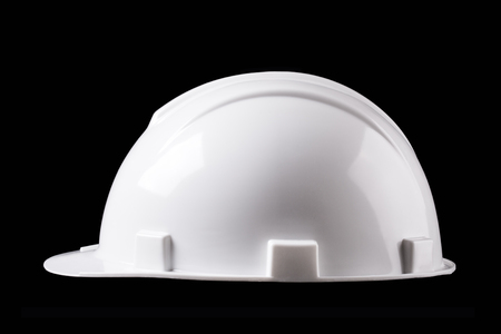 White construction helmet isolated on black backgroundの写真素材