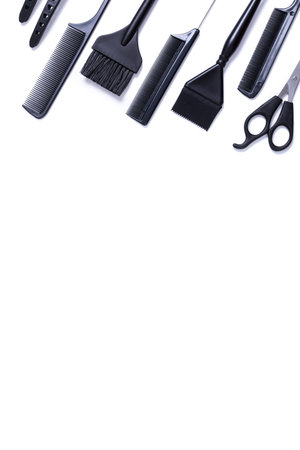 Hairdressing tools with copy space, combs and bleach brushes on white background, top view and flat...