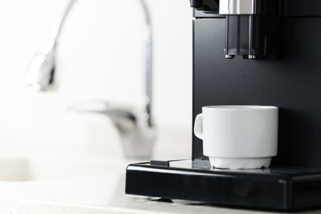 White cup stand in coffee machine and ready to do americanoの写真素材