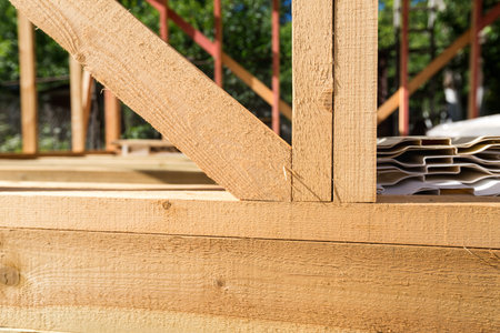 Unfinished frame house. Building process on construction siteの写真素材