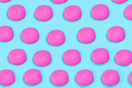 Creative pattern of citrus fruit pink color on blue background, flat layout. Trendy minimal pop art style. Concept colorful food.の写真素材