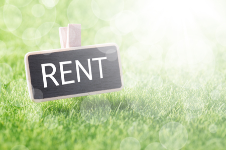Sign RENT on mockup board over green grass background, closeupの写真素材