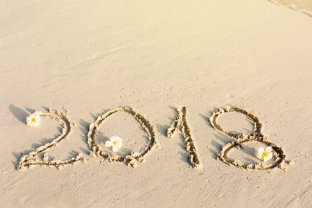 Handwritting inscription numbers 2018 on perfect tropical sandy beach, travel vacation concept card...