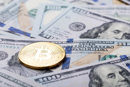 Bitcoins on dollar banknotes background, closeupの写真素材