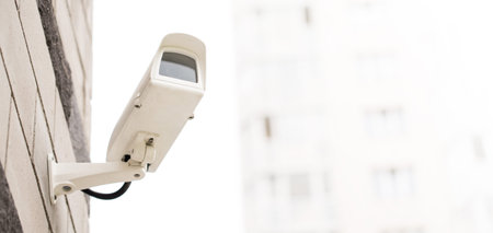 Surveillance camera on wall, outdoors. Video observation at modern house