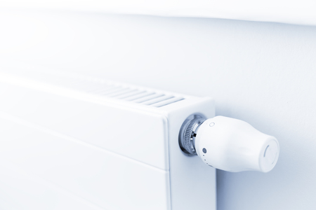 White heating radiator with a thermostat in room at home.の写真素材