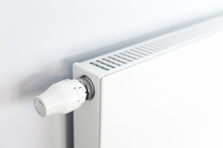 White heating radiator with a thermostat in room at home.の写真素材