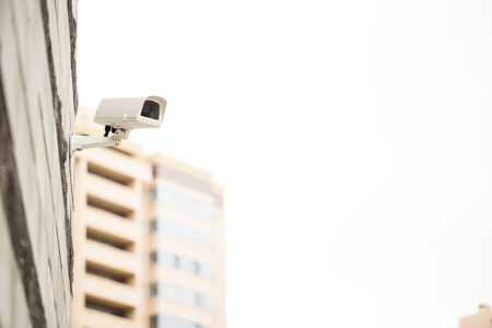 Surveillance camera on wall, outdoors. Video observation at modern houseの写真素材
