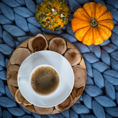 Autumn season concept of cozy home, hot coffee on merino plaid, top view, copyspaceの写真素材