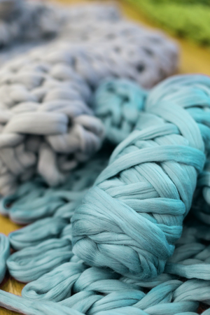 Merino wool knitted plaid, knitting process concept. Handmade trendy home decorationの写真素材