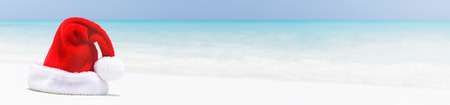 Santa hat on maldivian beach, concept of perfect holidays vacation, greeting card banner, copy spaceの写真素材