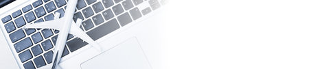 Plane on laptop keyboard. Booking tickets online. Nobody.Blue tone
