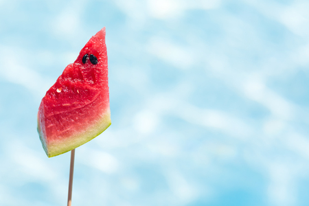 Tasty slice of tropical fruits on blue water pool backgroundの写真素材