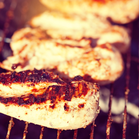 Grilled chicken breast on barbeque, macro cooking processの写真素材