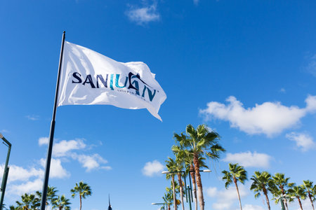 BAVARO, PUNTA CANA, DOMINICAN REPUBLIC - 19 JANUARY 2019: Sanjuan shopping center flag on blue sky...