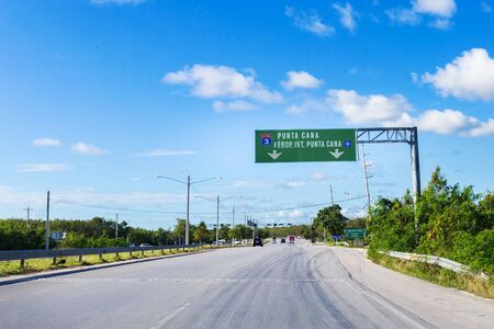 Traffic Sign PUNTA CANA AIRPORT with arrows on the roadのeditorial素材