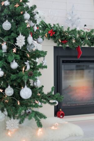 Scandinavian interior of rustic living room with fireplace decorated for Christmas holidays, greeting card, nobodyの写真素材
