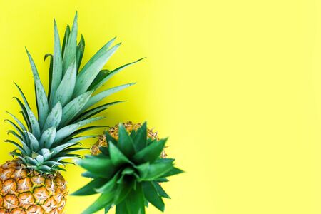 Summer tropical fruit composition. Tasty pineapple on yellow color background, flat lay.の写真素材
