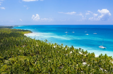 Aerial view from drone on caribbean sea with floating boat near tropical island. Summer vacations....