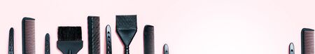 Hairdressing tools with copy space, combs and bleach brushes on pastel colored paper background, top view and flat layの写真素材