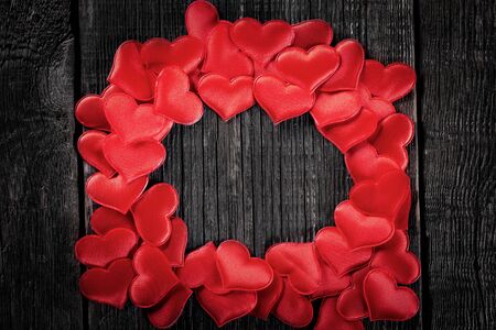 Heart frame on wooden rustic background. Valentines day celebration. Love card with copy spaceの写真素材
