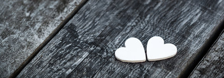 Wooden hearts on old rustic table. Valentine's holiday romantic card. Long banner