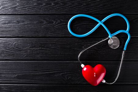 Stethoscope and heart on wooden background. Medicine concept. Nobodyの写真素材