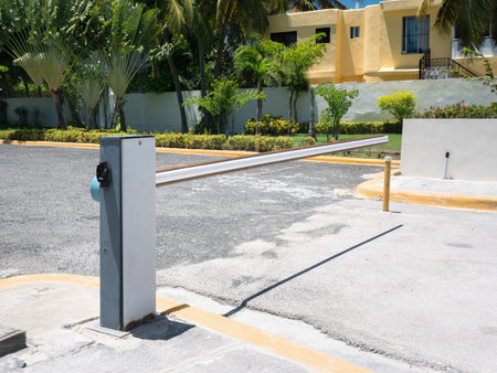 Entrance barrier gate to parking lot of caribbean house