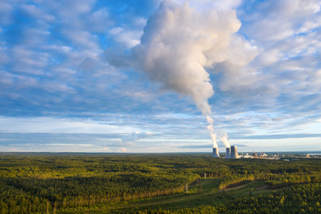 Aerial view from drone on smoking cooling towers at nuclear power plant